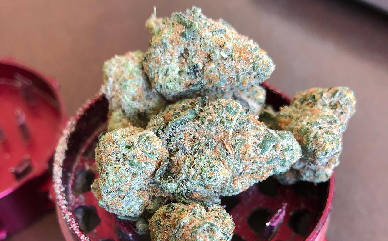 Powdery nugs of Alaskan Thunder Fuck weed in a grinder, image from Mrs. Dabbitude  on Instagram